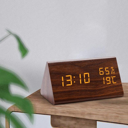 Stevvex wooden digital alarm clock with LED time display shows 13:10, 65% RH and 19°C on desk on Tampa Home & Garden Store