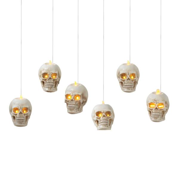Lighted hanging skulls set of 6, white skulls with glowing amber eyes on Tampa Home & Garden Store