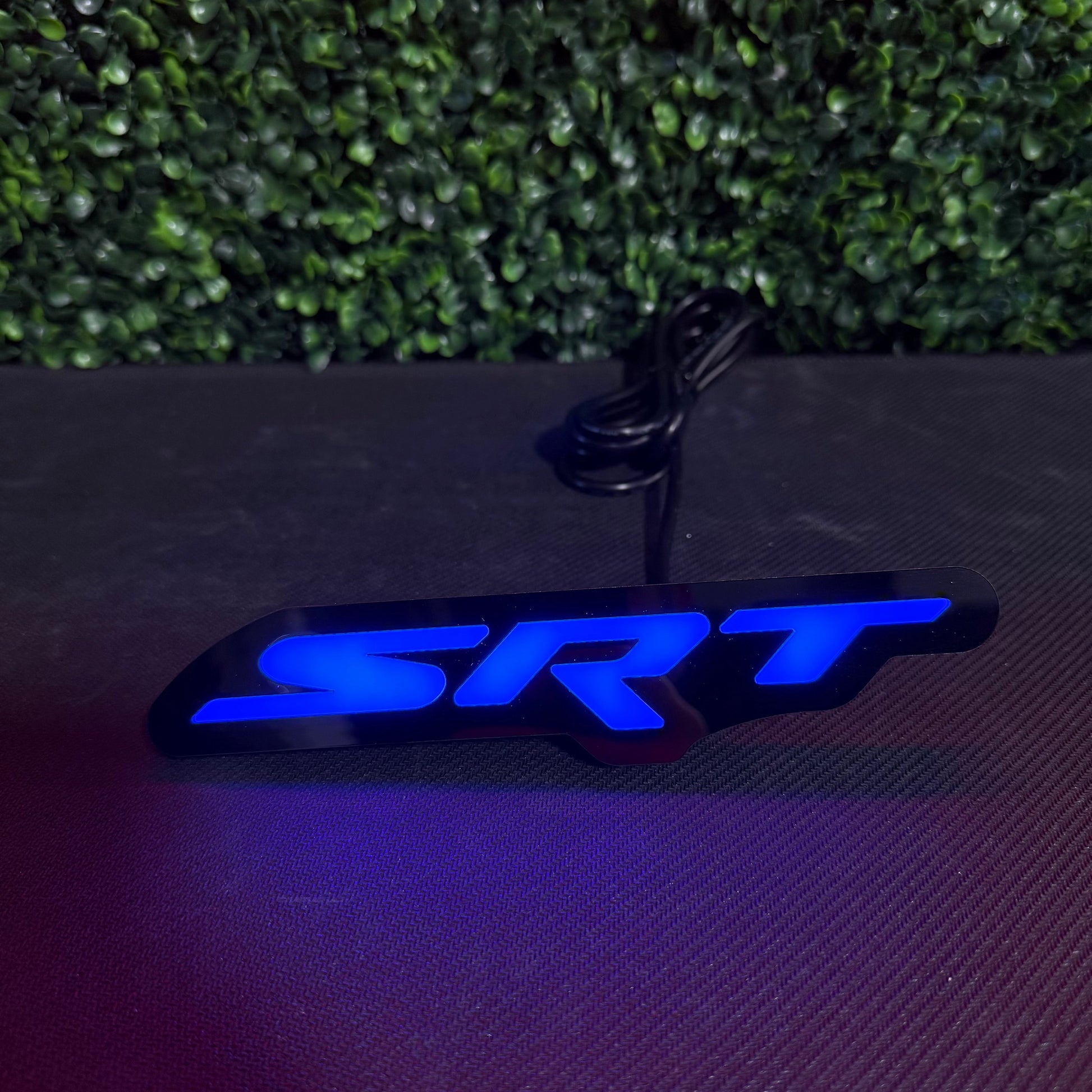 Dodge SRT RGBW Flow Series LED badge emblem, blue illuminated SRT lettering on black base on Tampa Home & Garden Store