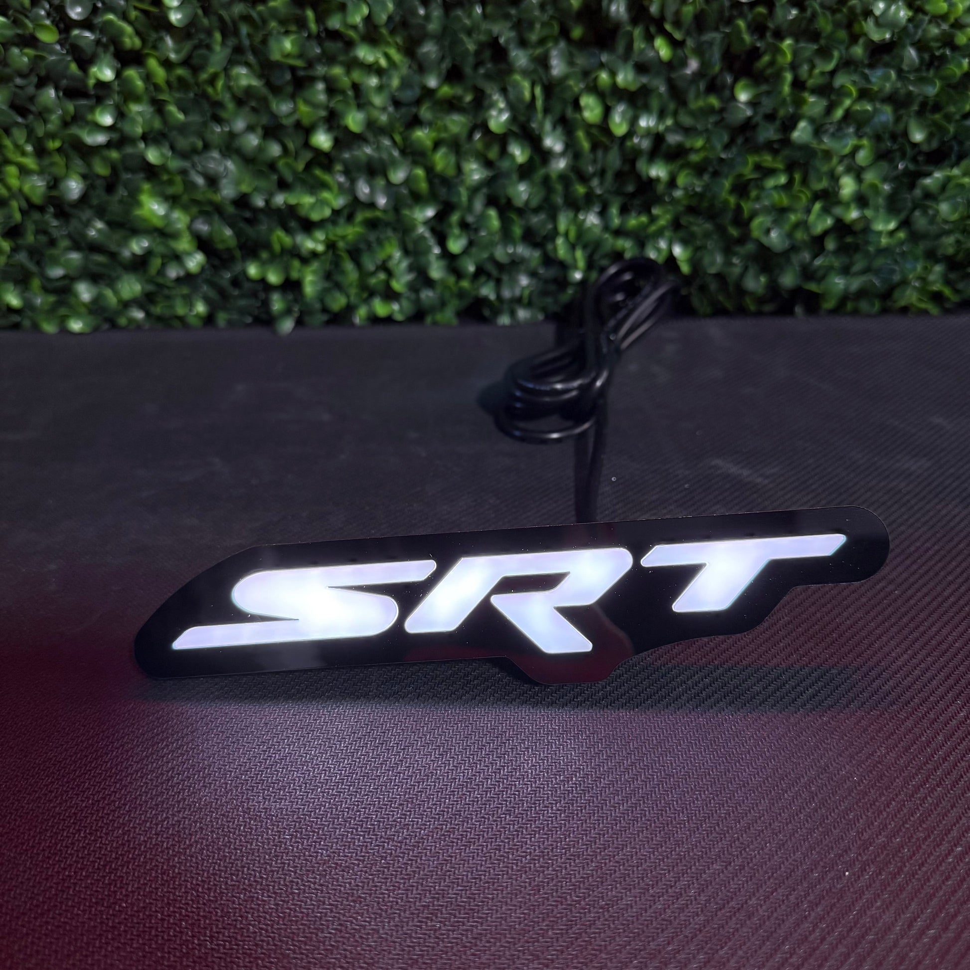 Dodge SRT RGBW Flow Series LED badge emblem with black housing and white illuminated SRT logo on Tampa Home & Garden Store