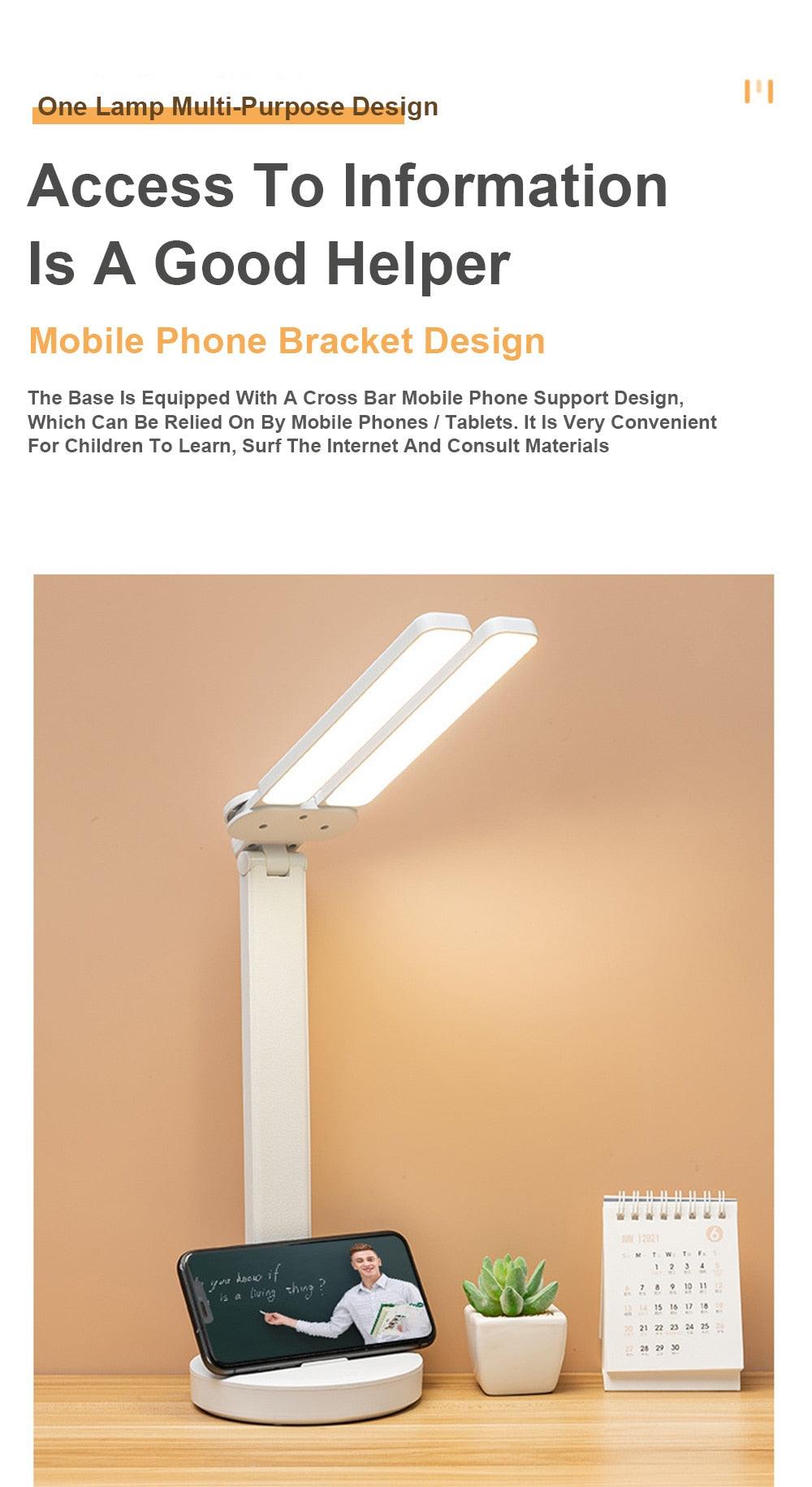 Double lamp-cap LED foldable reading lamp with phone bracket Stevvex on white desk on Tampa Home & Garden Store