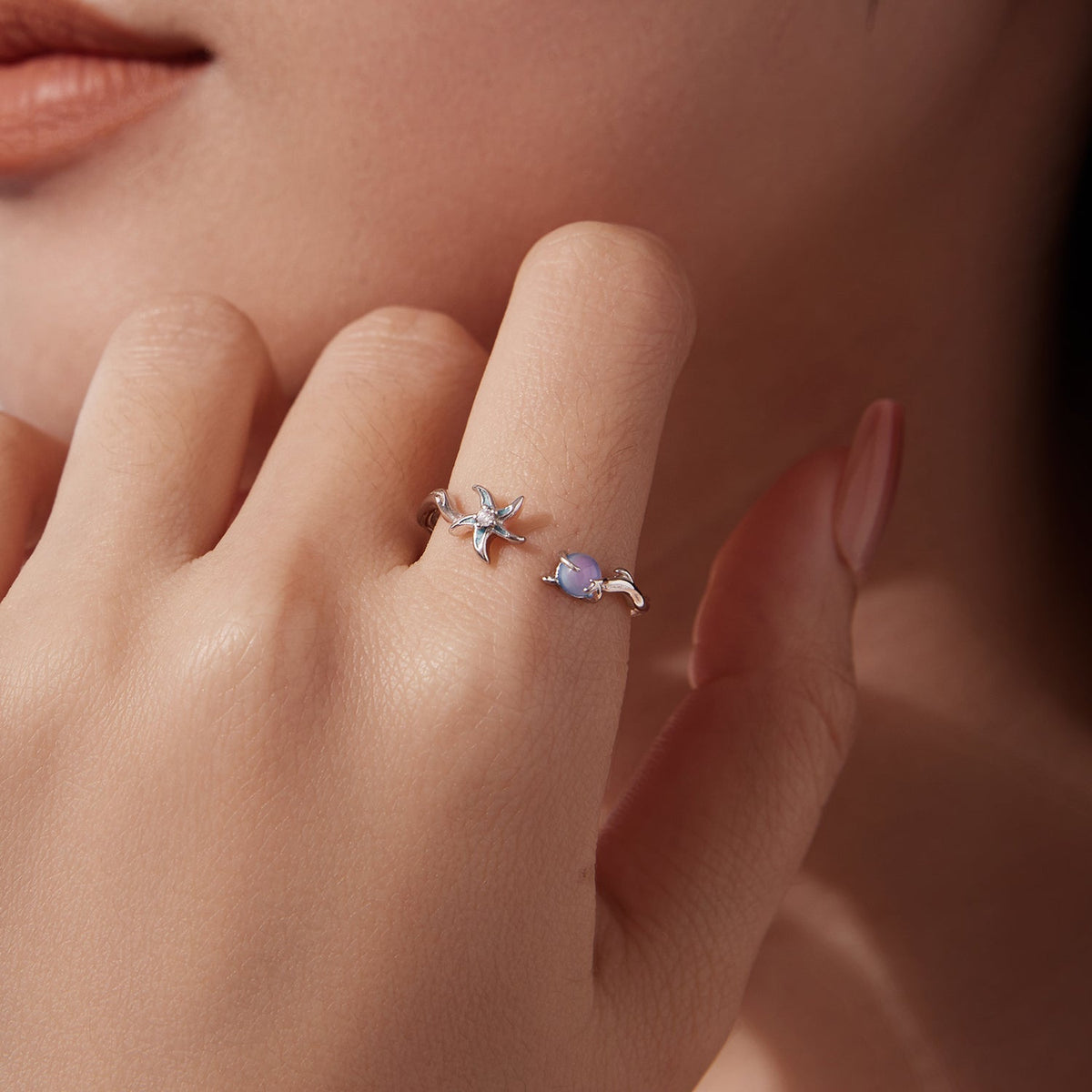 Pair of 925 Sterling Silver rings; white gold plating; starfish and lavender gemstone bands on finger on Tampa Home & Garden Store