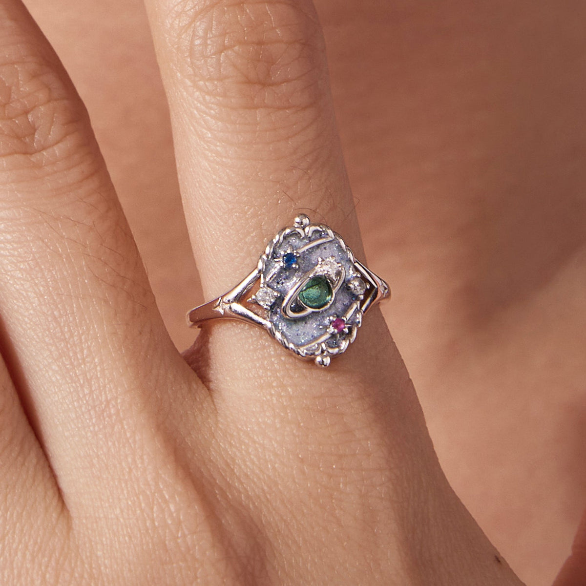 Sterling silver ring with a green center gemstone and blue and pink CZ accents on Tampa Home & Garden Store