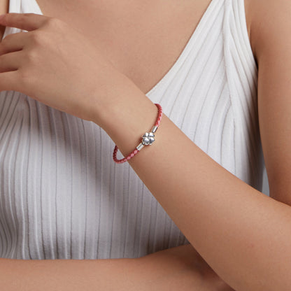 Pink braided leather bracelet with silver flower charm on wrist 17cm on Tampa Home & Garden Store