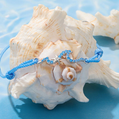 Bracelet 925 sterling silver waves motif with blue CZ stones and starfish charm on blue cord on Tampa Home & Garden Store