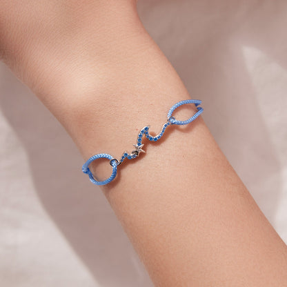 Sterling silver adjustable bracelet with blue CZ pendants on a blue cord band on Tampa Home & Garden Store