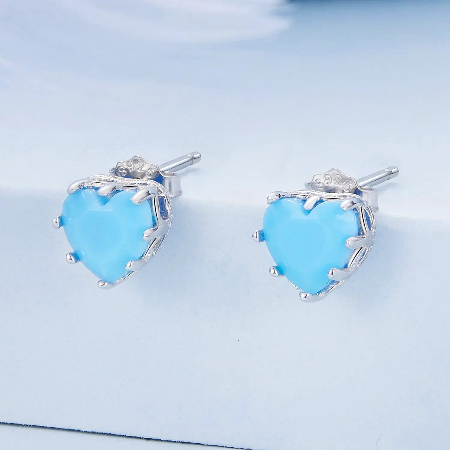 Sterling silver heart stud earrings with sky blue stones and pavé CZ accents on Tampa Home & Garden Store