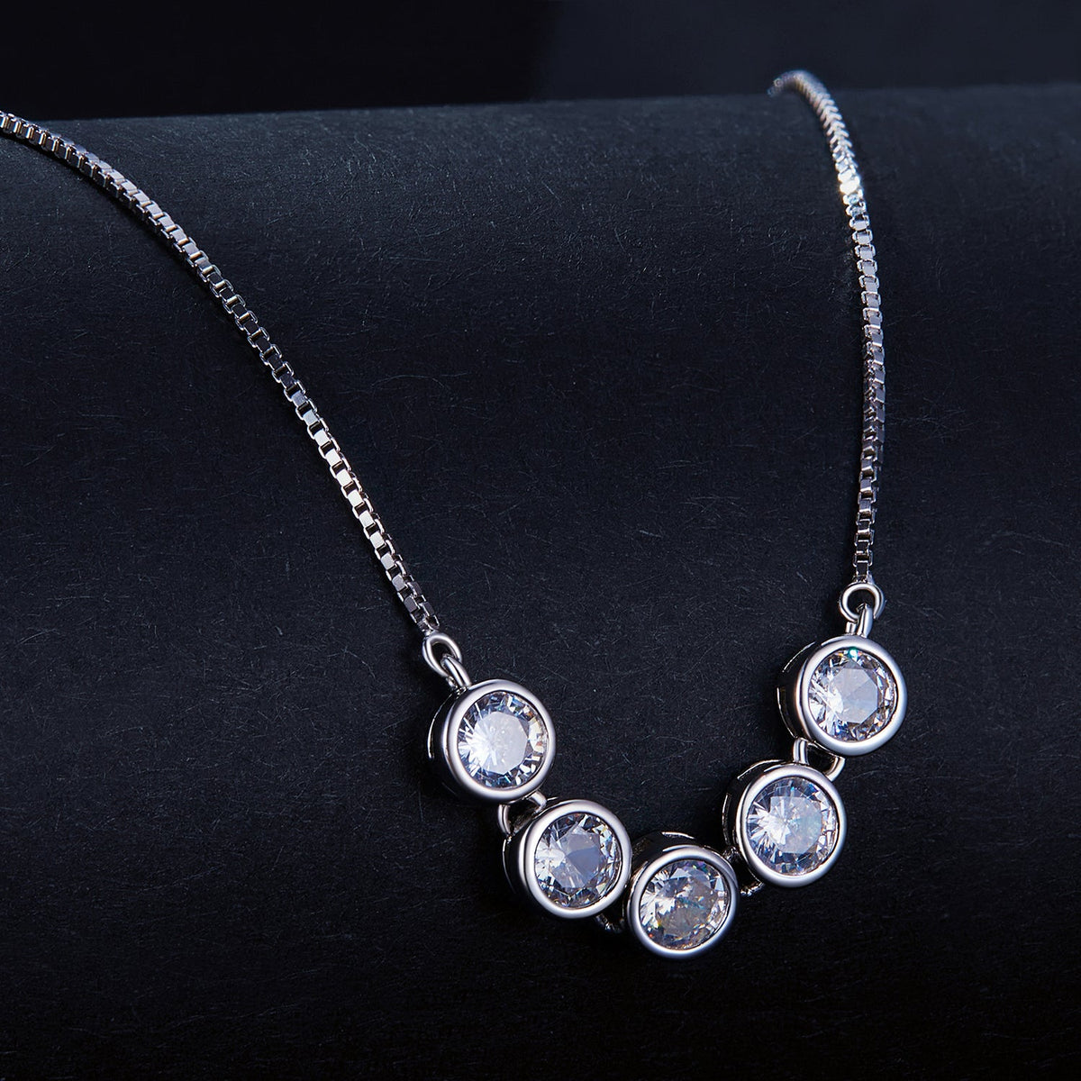 Necklace: 5 bezel-set moissanite stones, platinum-plated sterling silver, 4mm on box chain on Tampa Home & Garden Store