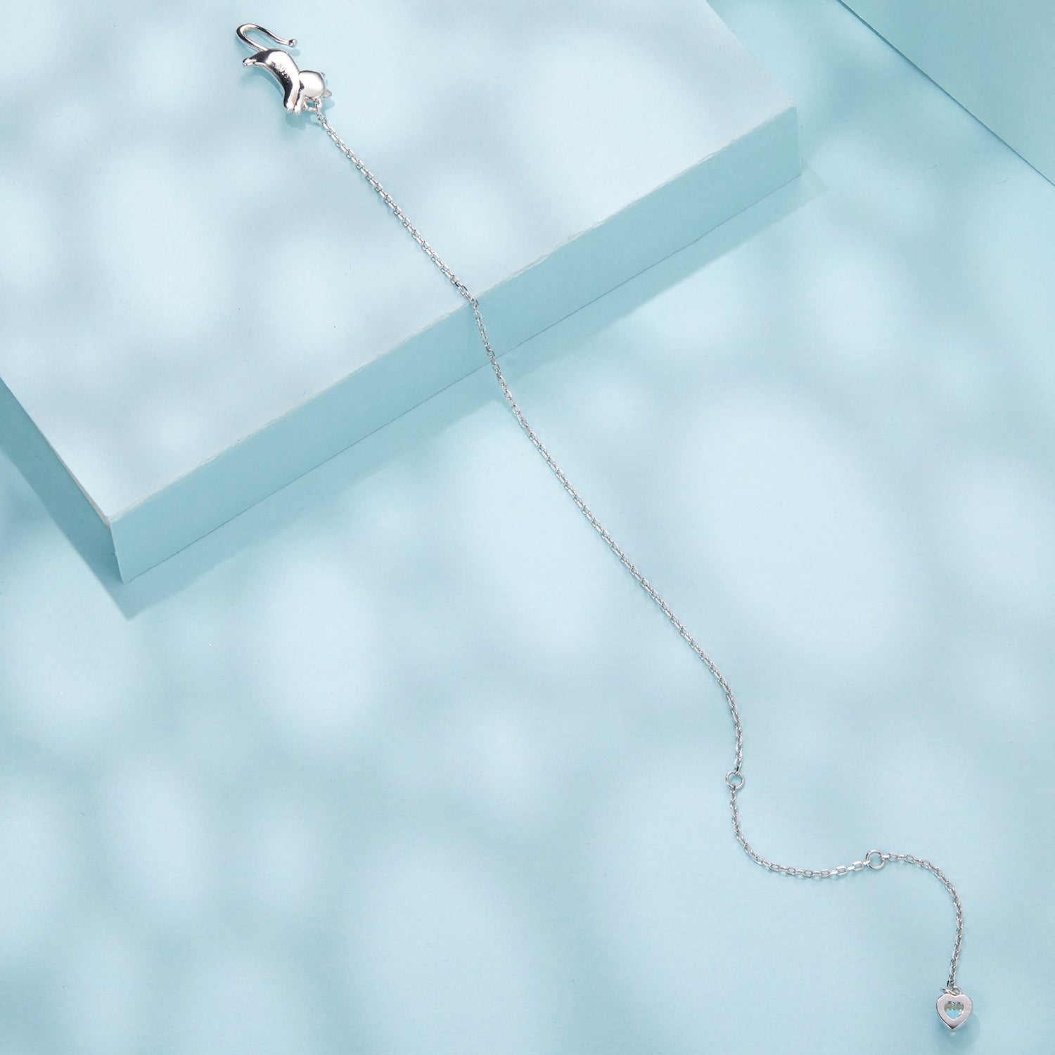 Sterling silver bracelet with heart pendant on a light blue background on Tampa Home & Garden Store