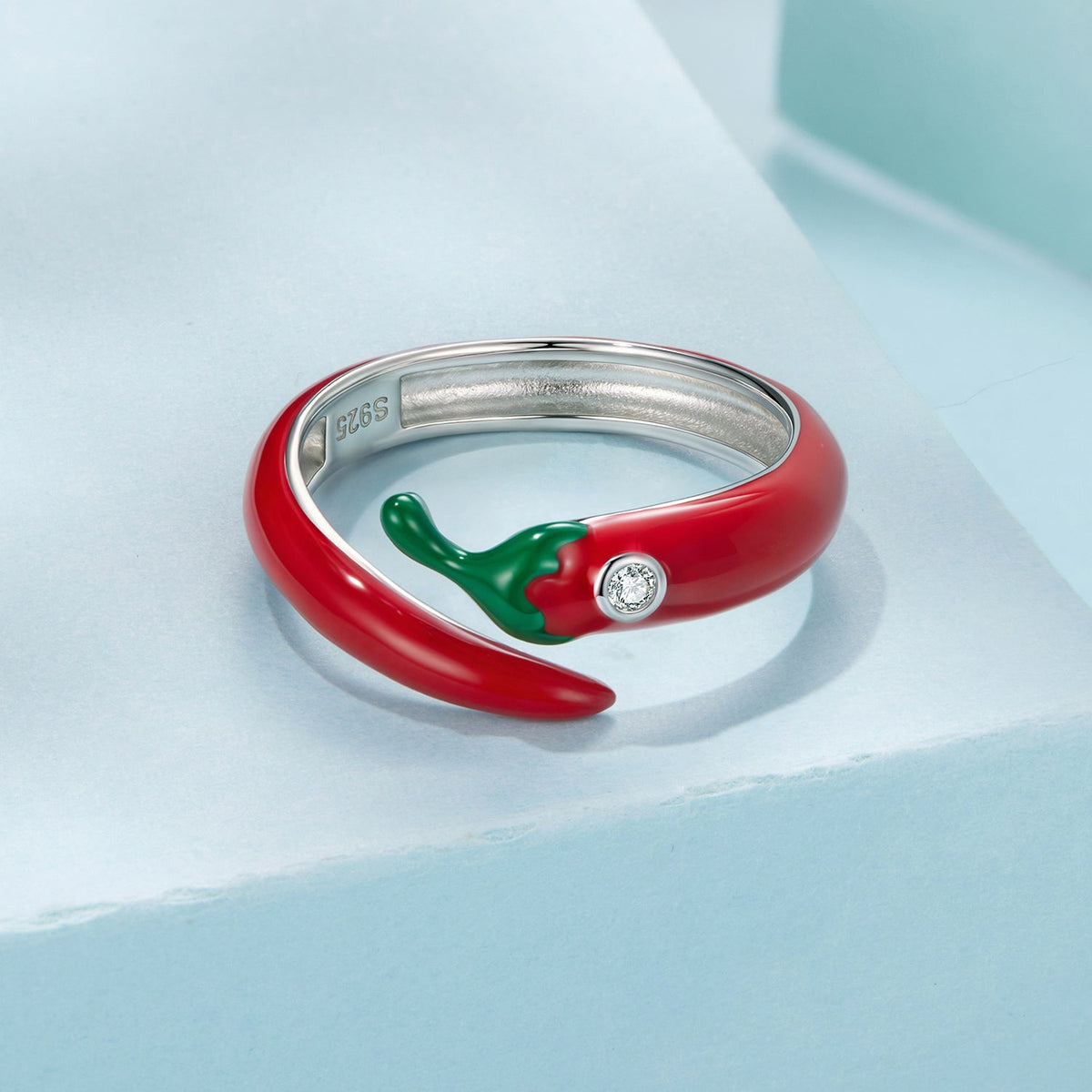 Red enamel open-band ring with silver inner edge, green leaf accent and a clear CZ stone on Tampa Home & Garden Store