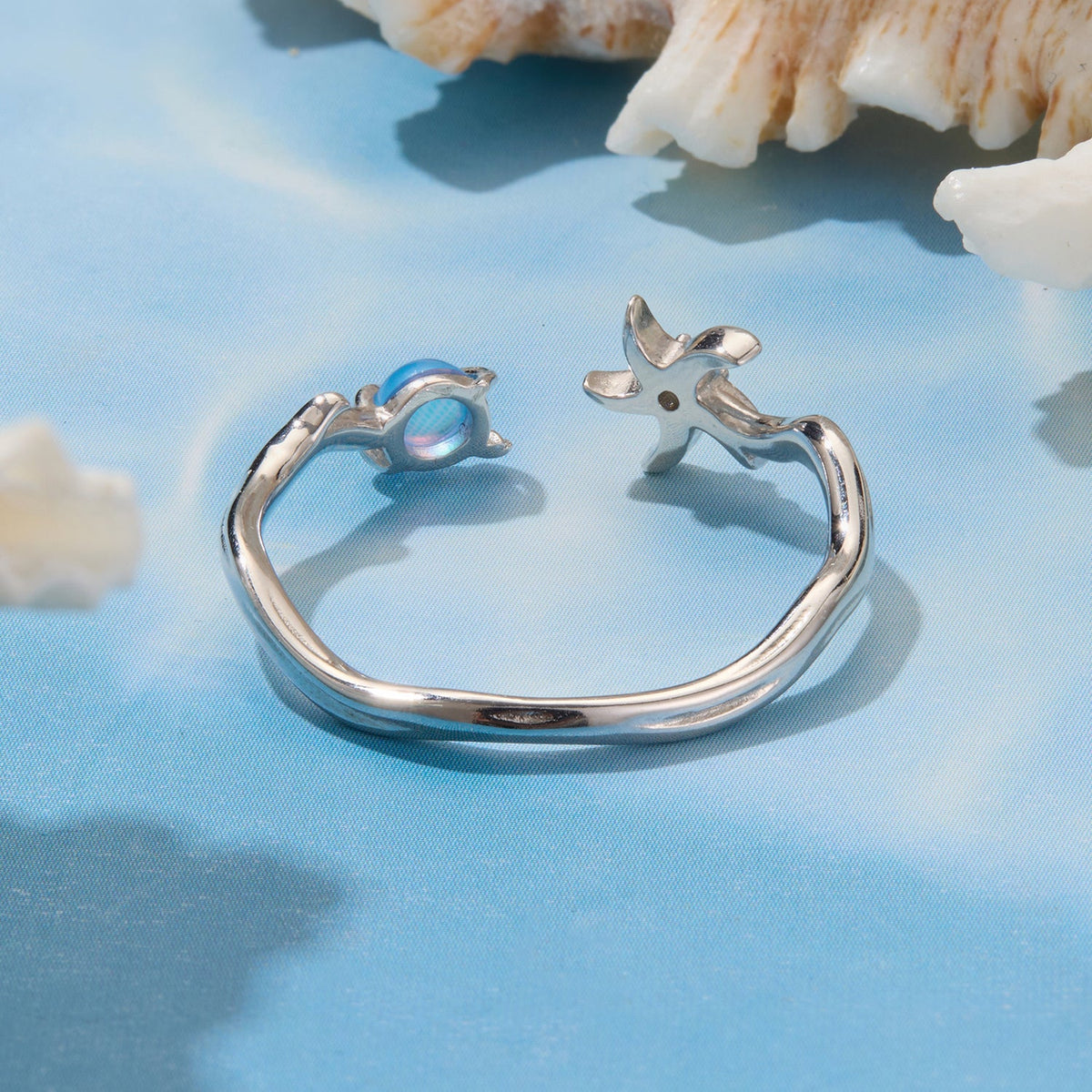 Sterling silver ring with white gold plating, blue cabochon end and starfish motif on Tampa Home & Garden Store