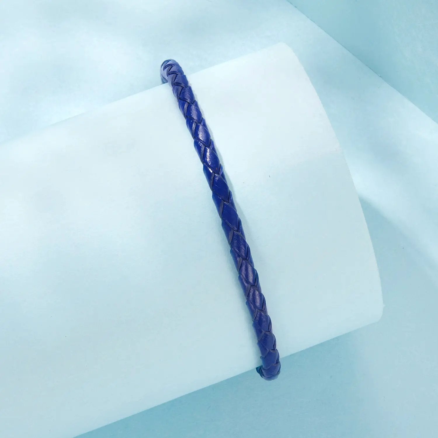 Leather rope bracelet in blue for women with braided texture on pale blue background on Tampa Home & Garden Store