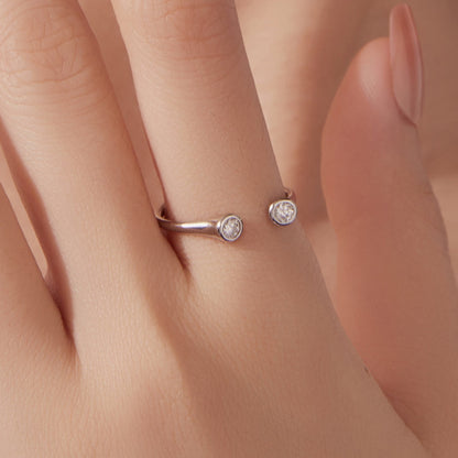 Two 925 Sterling Silver Moissanite Rings, size E, bezel-set stones on curved open bands on Tampa Home & Garden Store