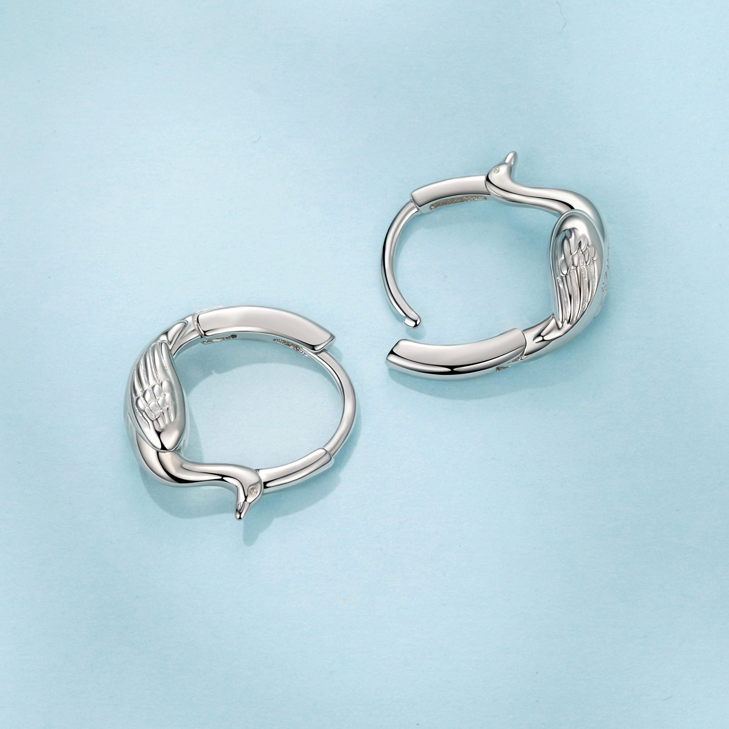 Hoop earrings silver plated white gold finish with wing motif, open hinged design on Tampa Home & Garden Store