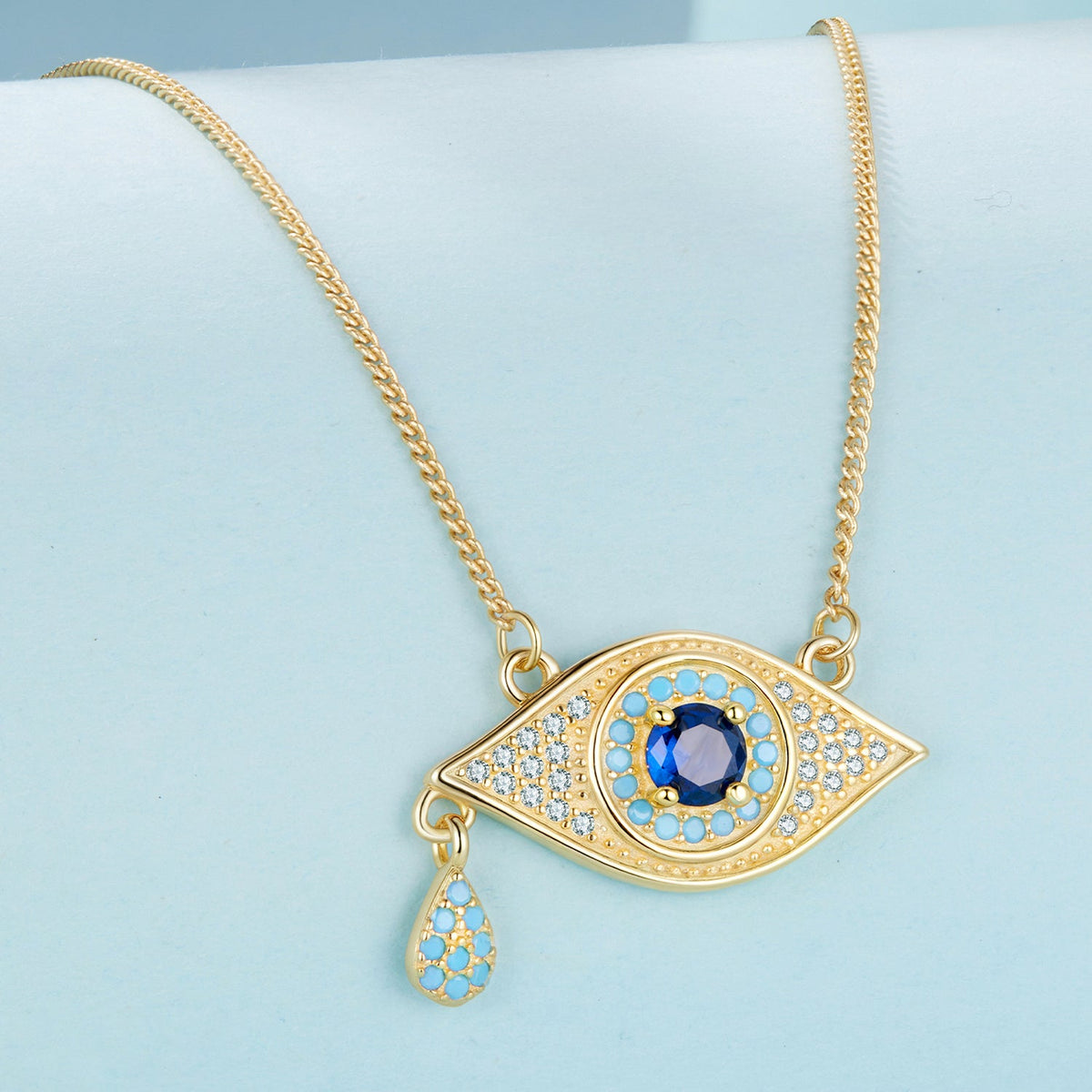 Gold-tone eye pendant necklace with blue center gem and pavé crystals on curb chain 40+5cm on Tampa Home & Garden Store