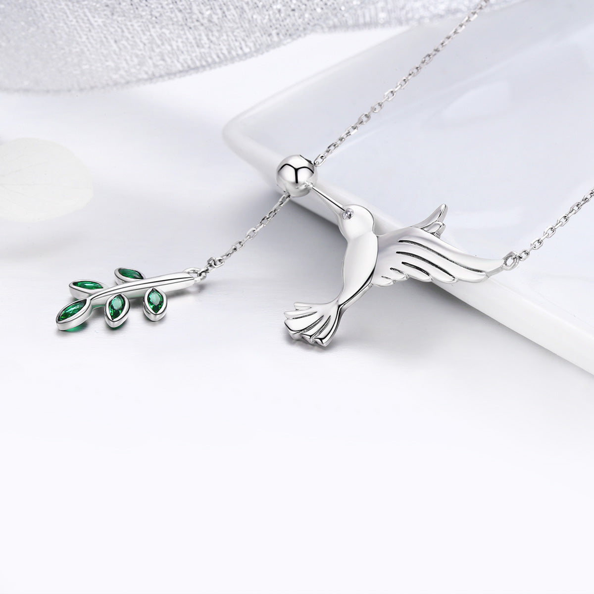 Sterling silver necklace with two pendants: bird and green-stone leaf charm for women on Tampa Home & Garden Store