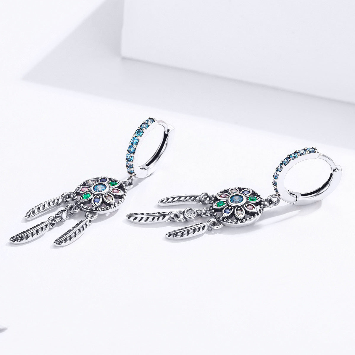 Oxidized 925 silver CZ earrings with blue pavé hoops and feather drops on Tampa Home & Garden Store