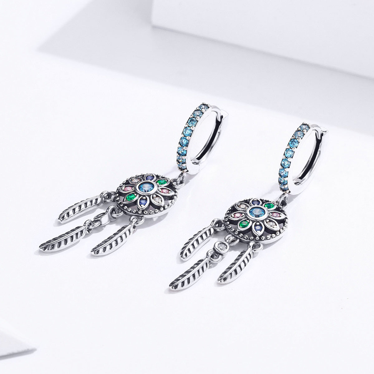 Oxidized sterling silver pavé CZ hoop earrings with blue stones and feather charms, 4x1 cm on Tampa Home & Garden Store
