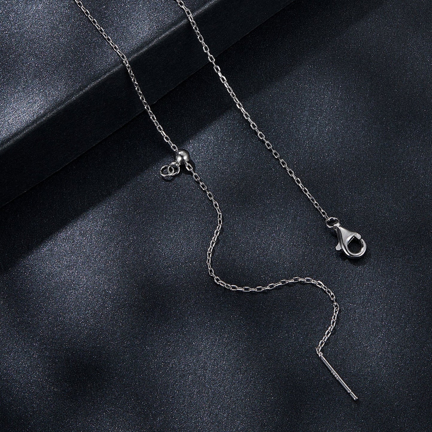 Sterling silver moissanite necklace with heart charm and pendant on glitter backdrop on Tampa Home & Garden Store