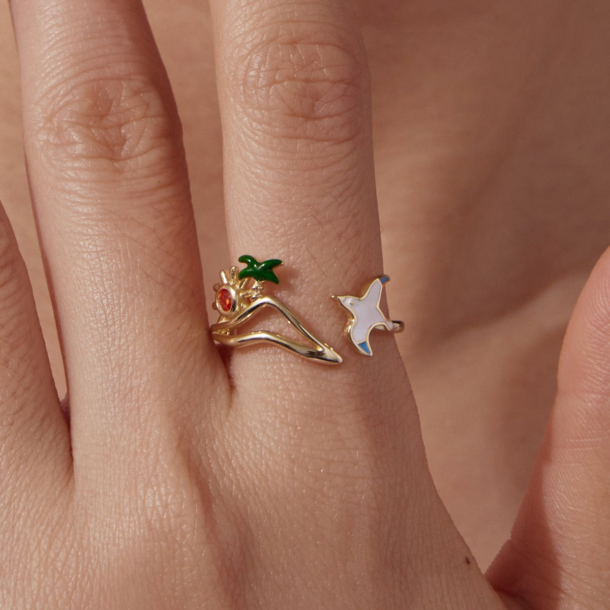 Gold-plated open ring with sun motif red gem and green leaf, plus white enamel star charm on split shank on Tampa Home & Garden Store