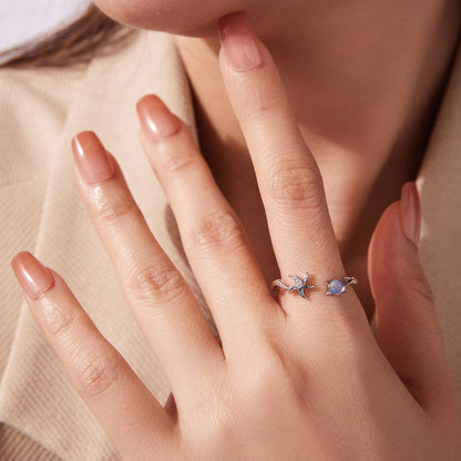 Sterling silver ring with white gold plating; starfish-wave band and blue gemstone accents on two fingers on Tampa Home & Garden Store