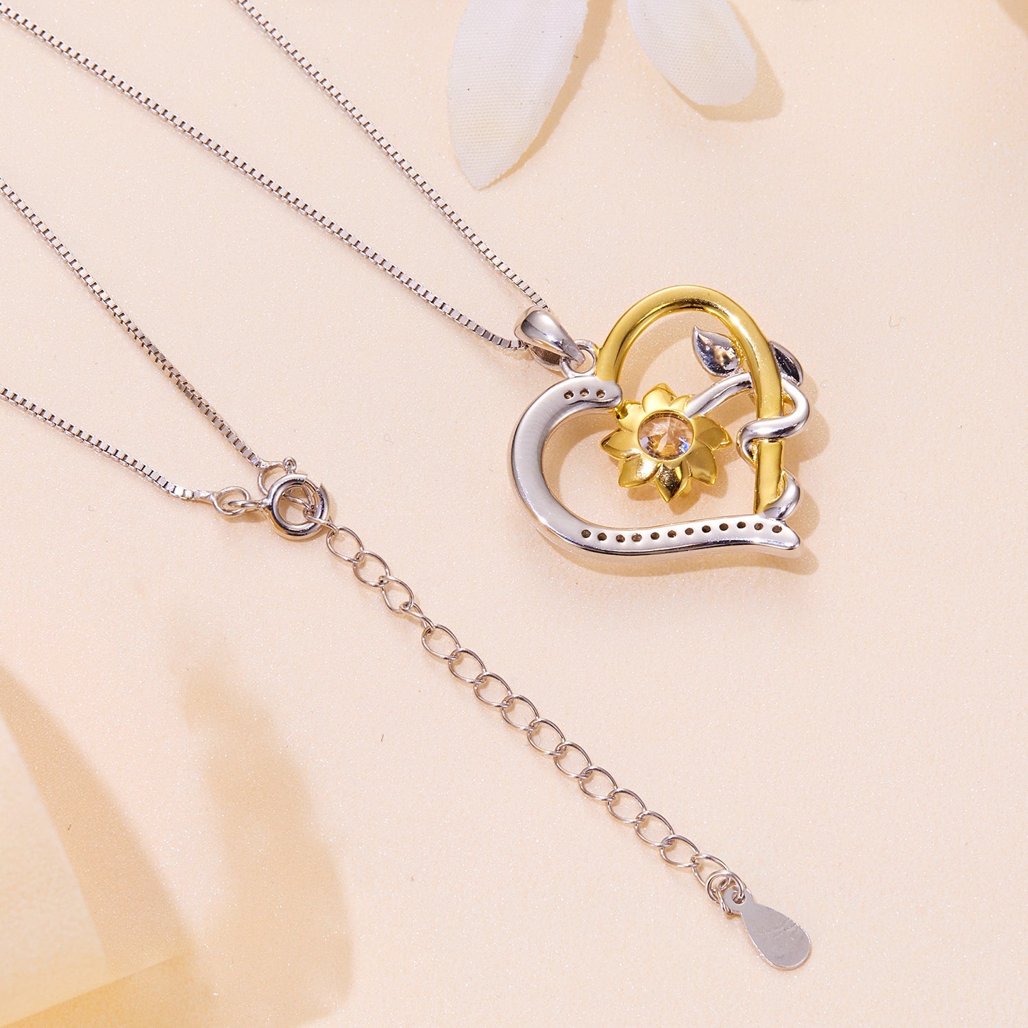 Necklace pendant in two-tone silver and gold with moissanite pavé heart and flower on Tampa Home & Garden Store