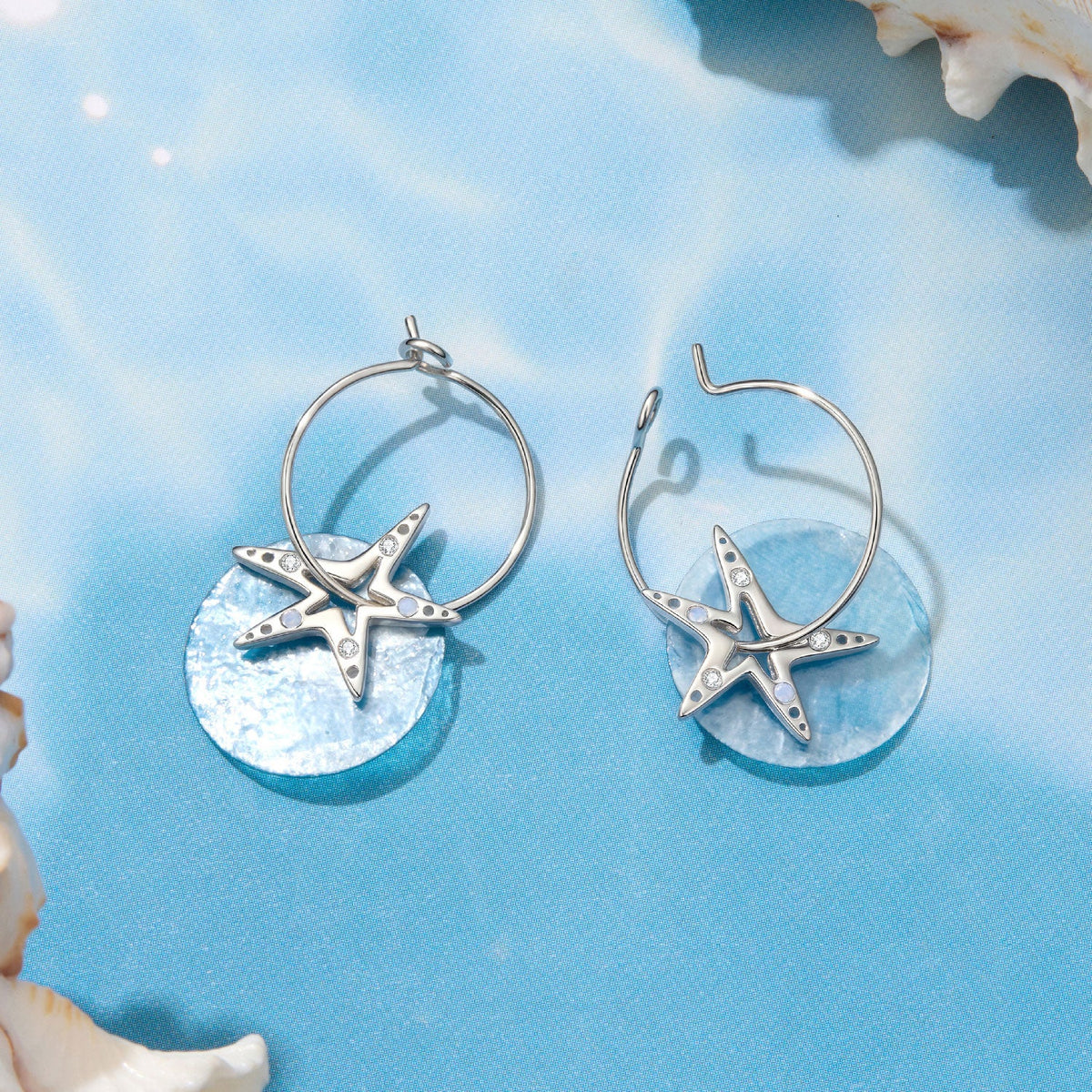 Pair of 925 sterling silver hoop earrings with white gold plated starfish charms and CZ stones on Tampa Home & Garden Store