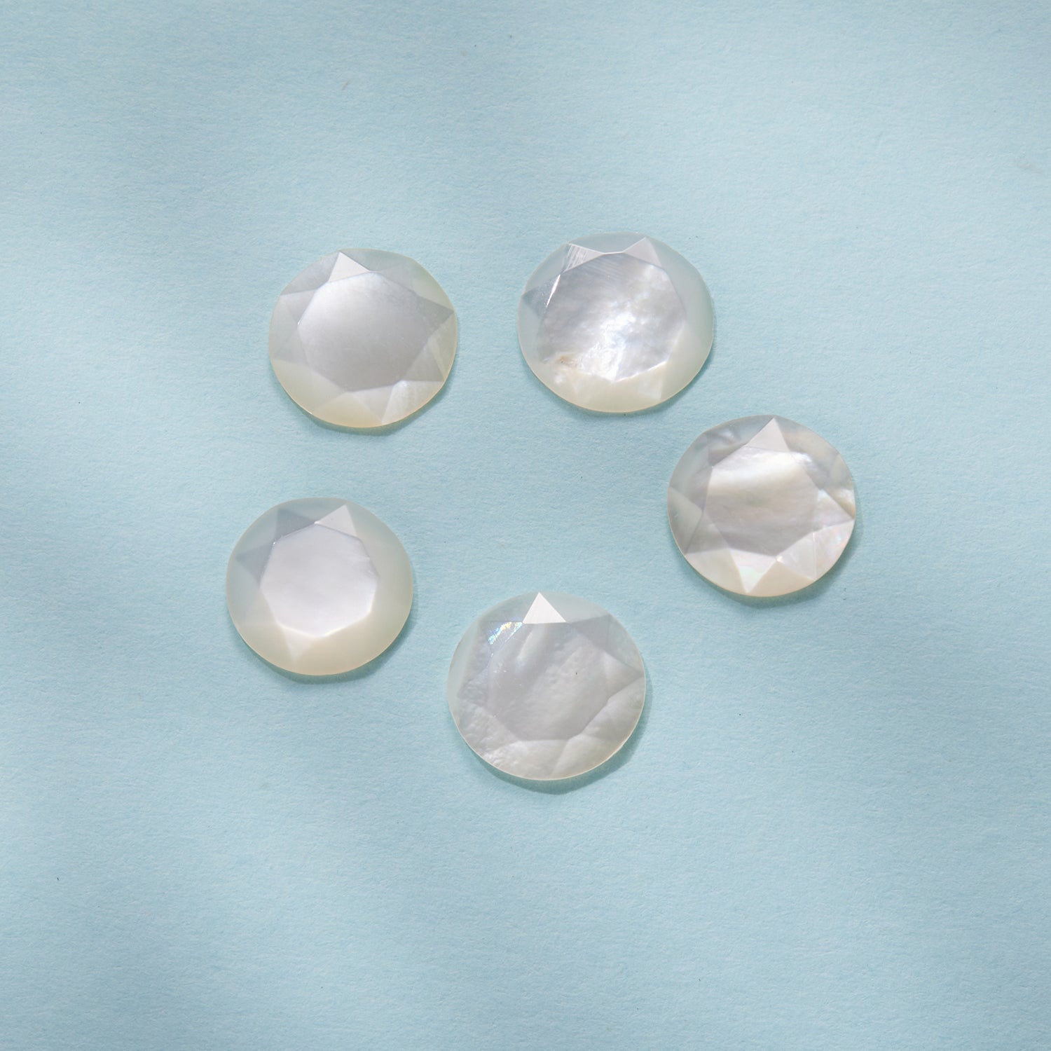 Six round faceted nacre stones with iridescent white sheen on Tampa Home & Garden Store