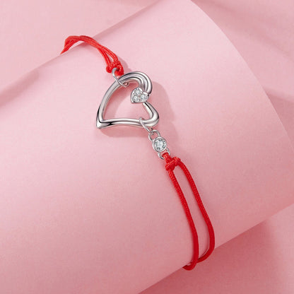 Bracelet with open silver heart charm and small CZ pave heart accent on red cord on Tampa Home & Garden Store