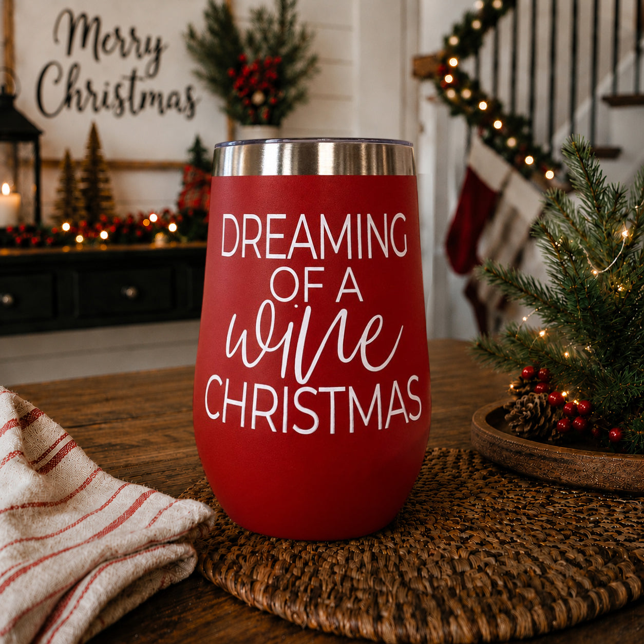 Red 17oz tumbler with silver rim displaying Dreaming of a wine Christmas on a holiday table on Tampa Home & Garden Store