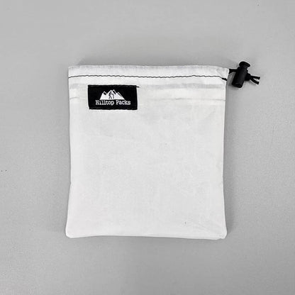 Dual Pocket Battery Bags white pouch with black Hilltop Packs LLC label and drawstring closure on Tampa Home & Garden Store