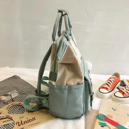 Teal backpack with beige interior, side pocket and padded straps; laptop-ready travel bag on Tampa Home & Garden Store