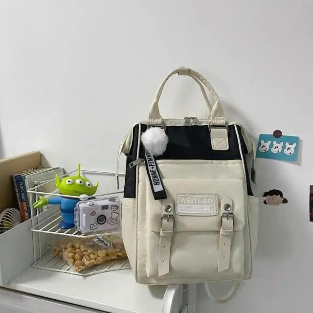 Stevvex laptop backpack beige and black with buckle pockets and fluffy pom-pom charm on Tampa Home & Garden Store