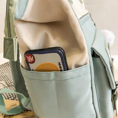 Stevvex laptop backpack in mint blue with front pocket and side pocket holding a phone on Tampa Home & Garden Store