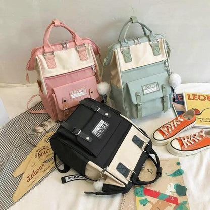 Laptop backpacks by Stevvex in pink, mint green, and black patchwork with ring accents on Tampa Home & Garden Store