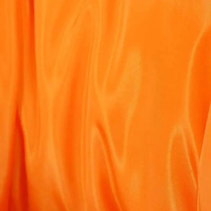 Durable faux PU leather bubble puffer jacket fabric close-up in bright orange on Tampa Home & Garden Store
