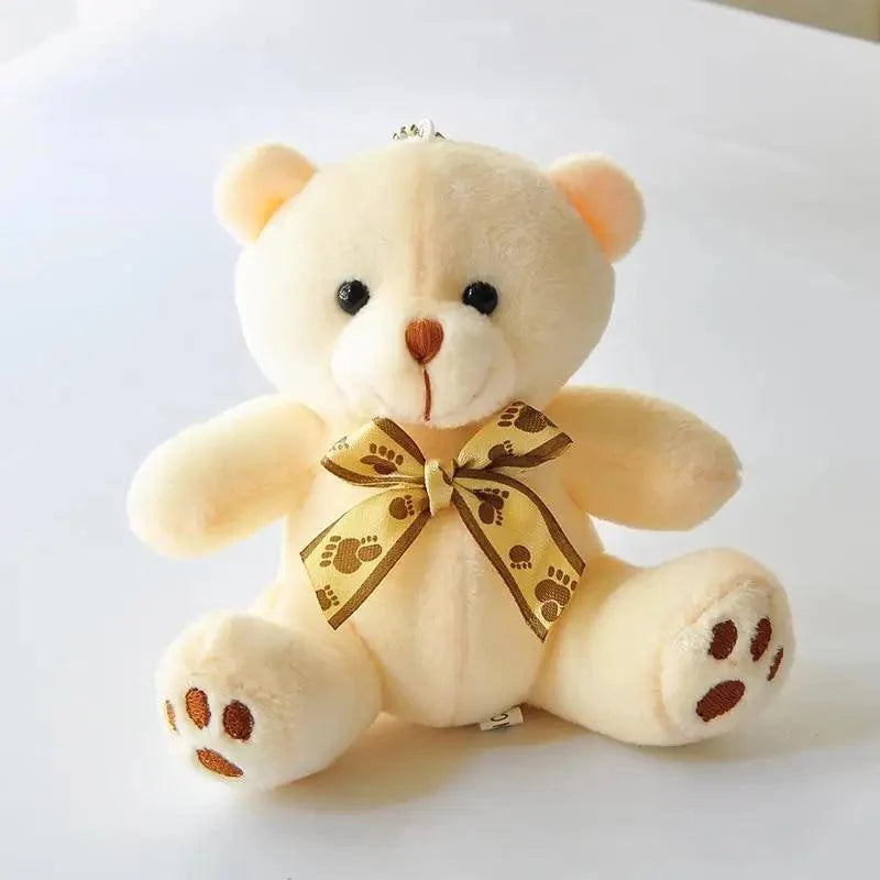 Stevvex cream teddy bear plush with gold paw-print bow, soft small stuffed animal on Tampa Home & Garden Store