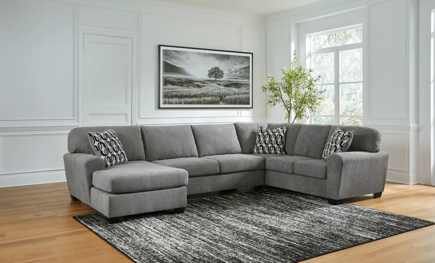 Birkdale Court Sectional in gray fabric with chaise and patterned pillows on Tampa Home & Garden Store
