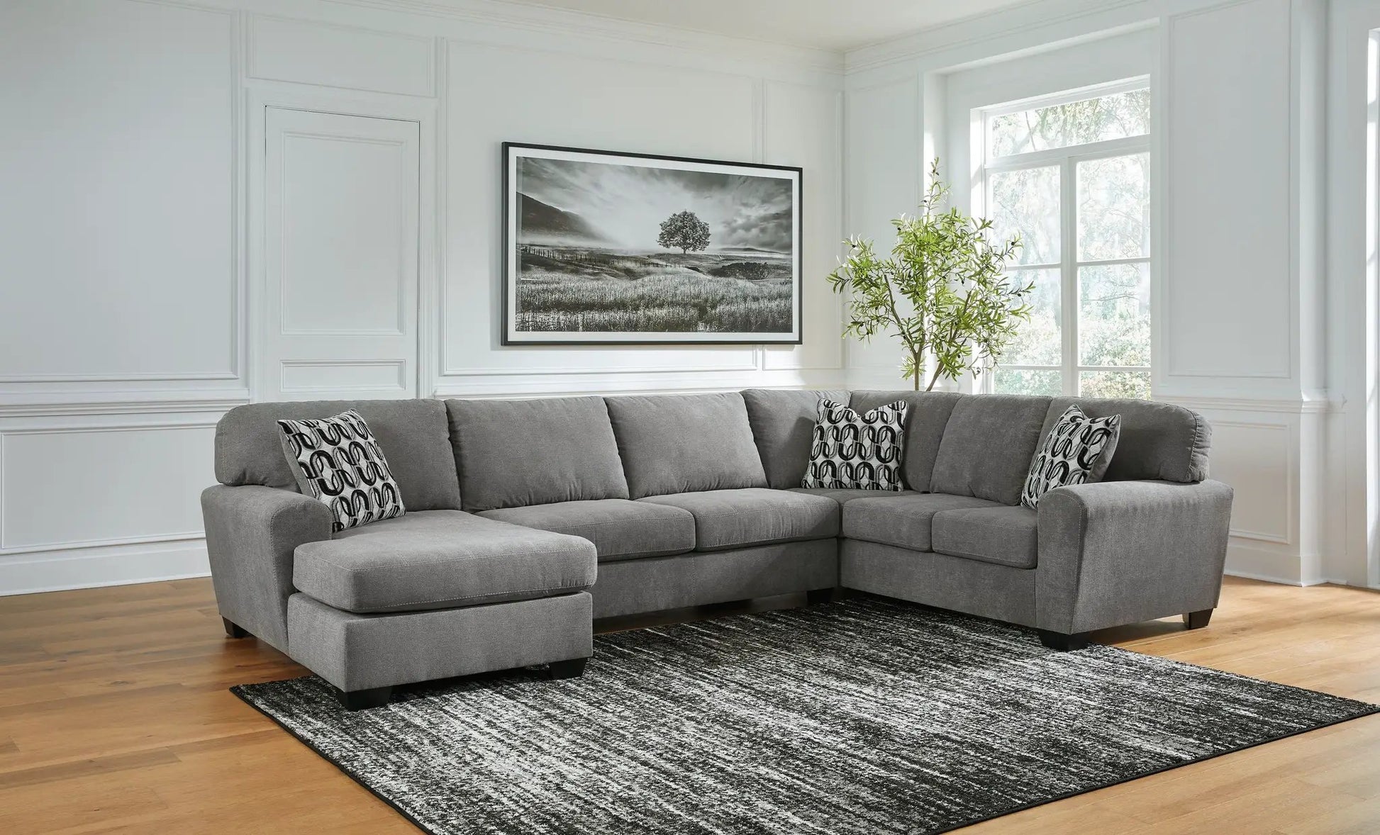 Birkdale Court Sectional in gray fabric with chaise and patterned pillows on Tampa Home & Garden Store