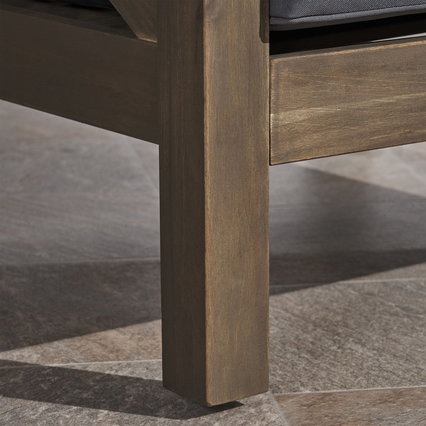 Brava Club Chair; brown wood frame with dark gray water resistant cushions on Tampa Home & Garden Store