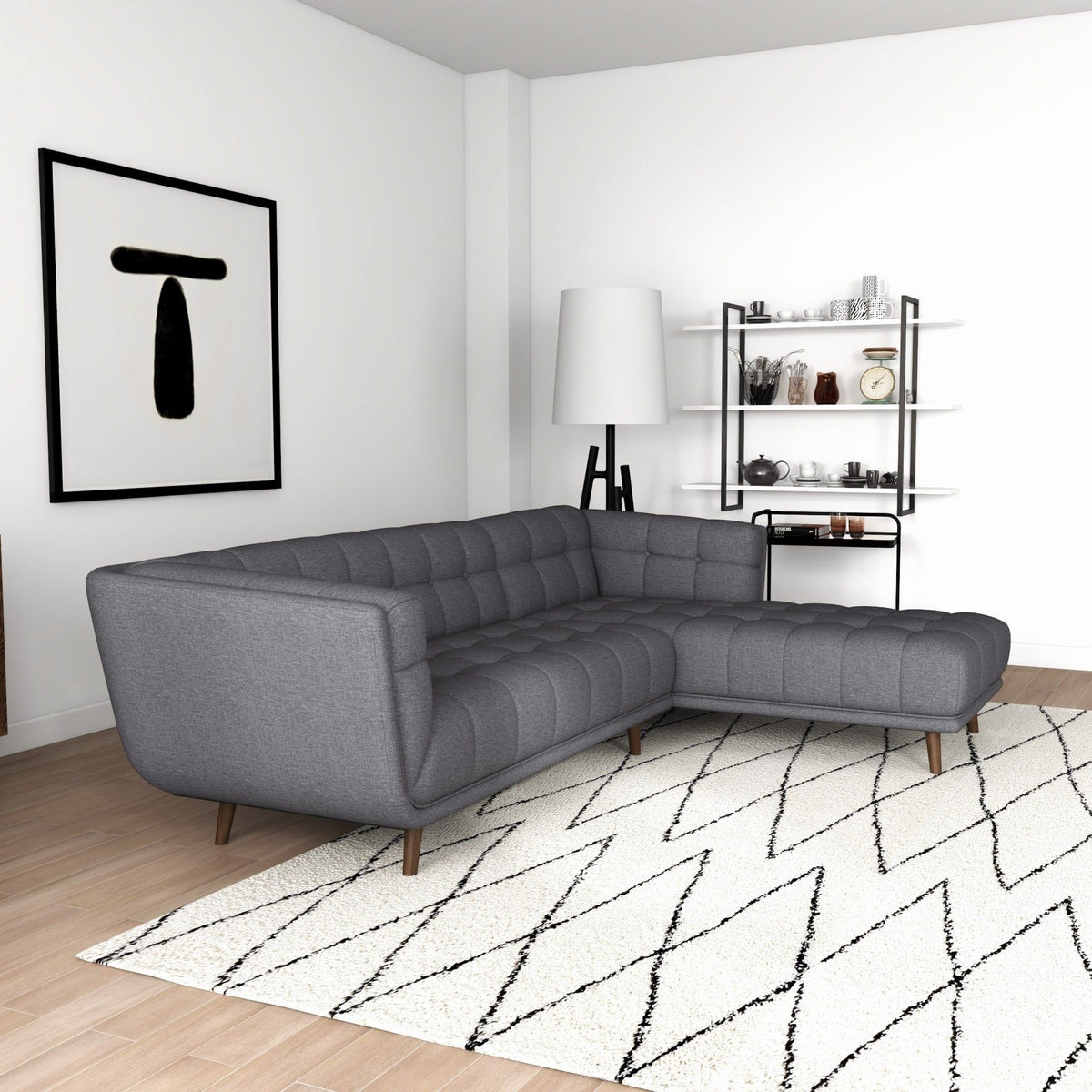 L-shaped tufted sectional sofa in dark gray with mid-century legs in a modern living room on Tampa Home & Garden Store