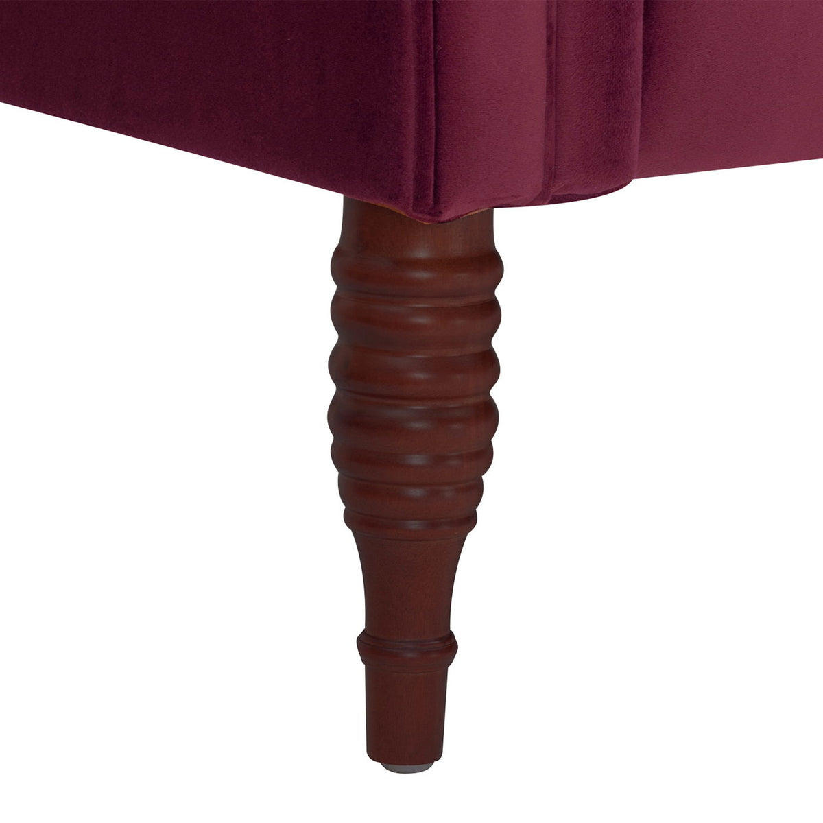 Tufted chaise lounge closeup in dark red velvet with a ribbed brown wooden leg on Tampa Home & Garden Store
