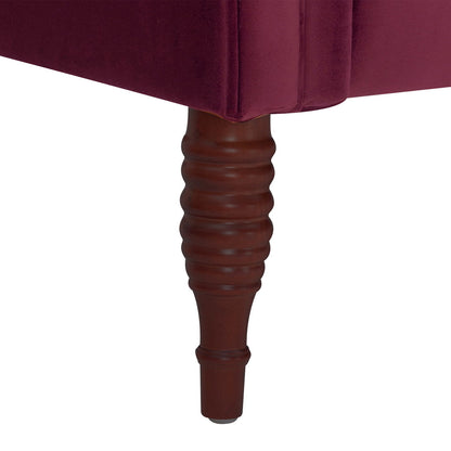 Tufted chaise lounge closeup in dark red velvet with a ribbed brown wooden leg on Tampa Home & Garden Store