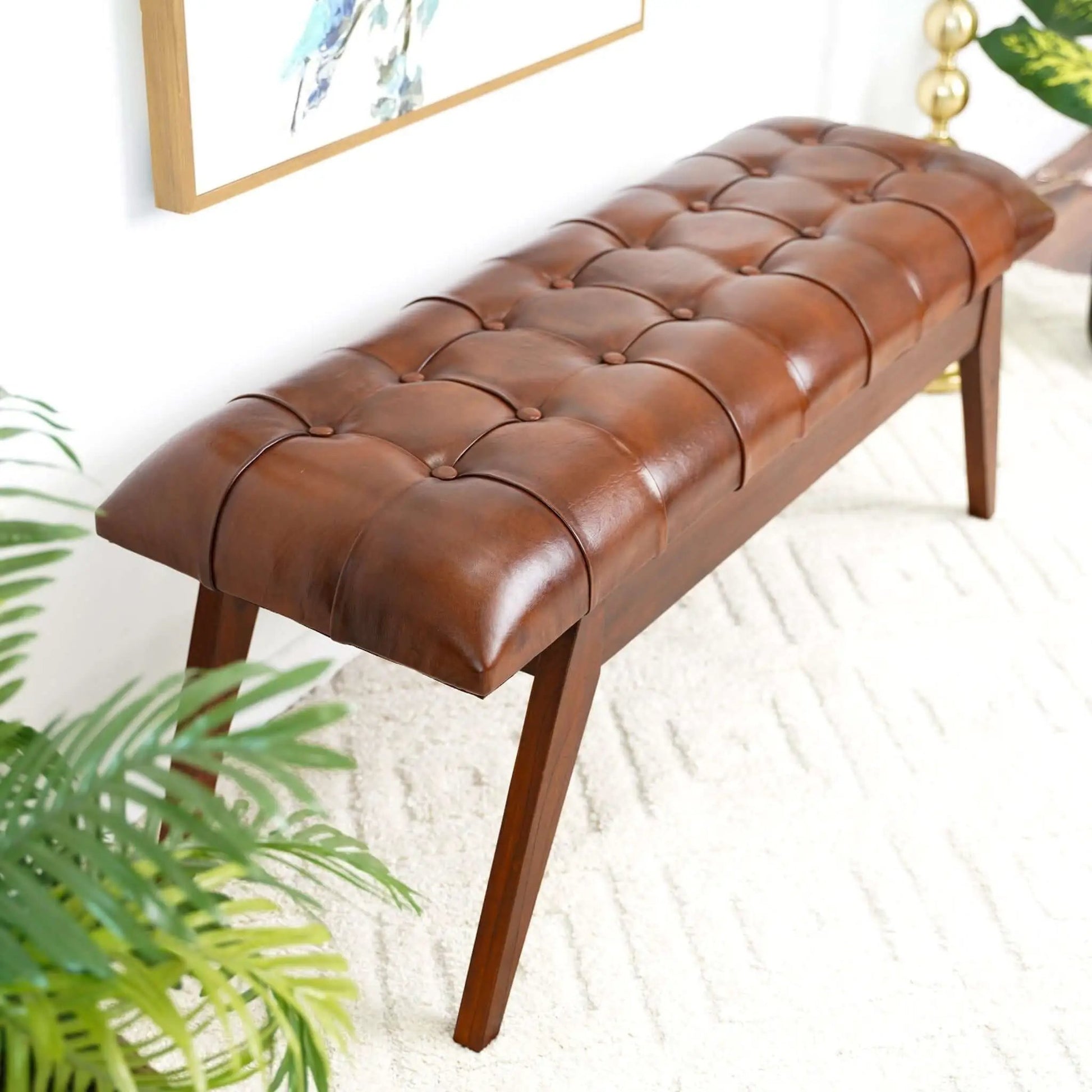 Maja bench by Unique Piece Furniture in cognac leather with tufted top and wooden legs on Tampa Home & Garden Store