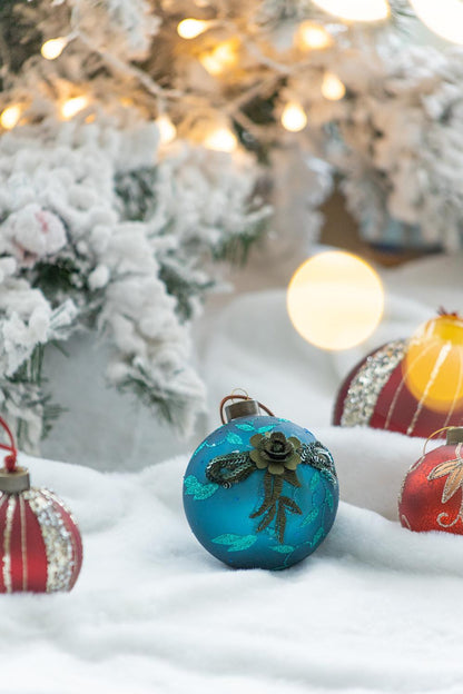 Blue glass Christmas ball ornament with teal glitter leaf pattern and metallic cap on Tampa Home and Garden Store