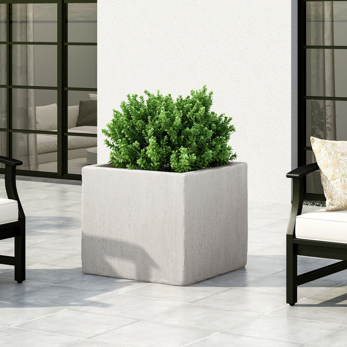 Modern outdoor planter in gray textured concrete with lush green shrub on Tampa Home & Garden Store