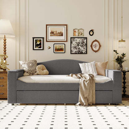 Upholstered grey daybed with storage drawer and beige pillows in a stylish living room on Tampa Home & Garden Store