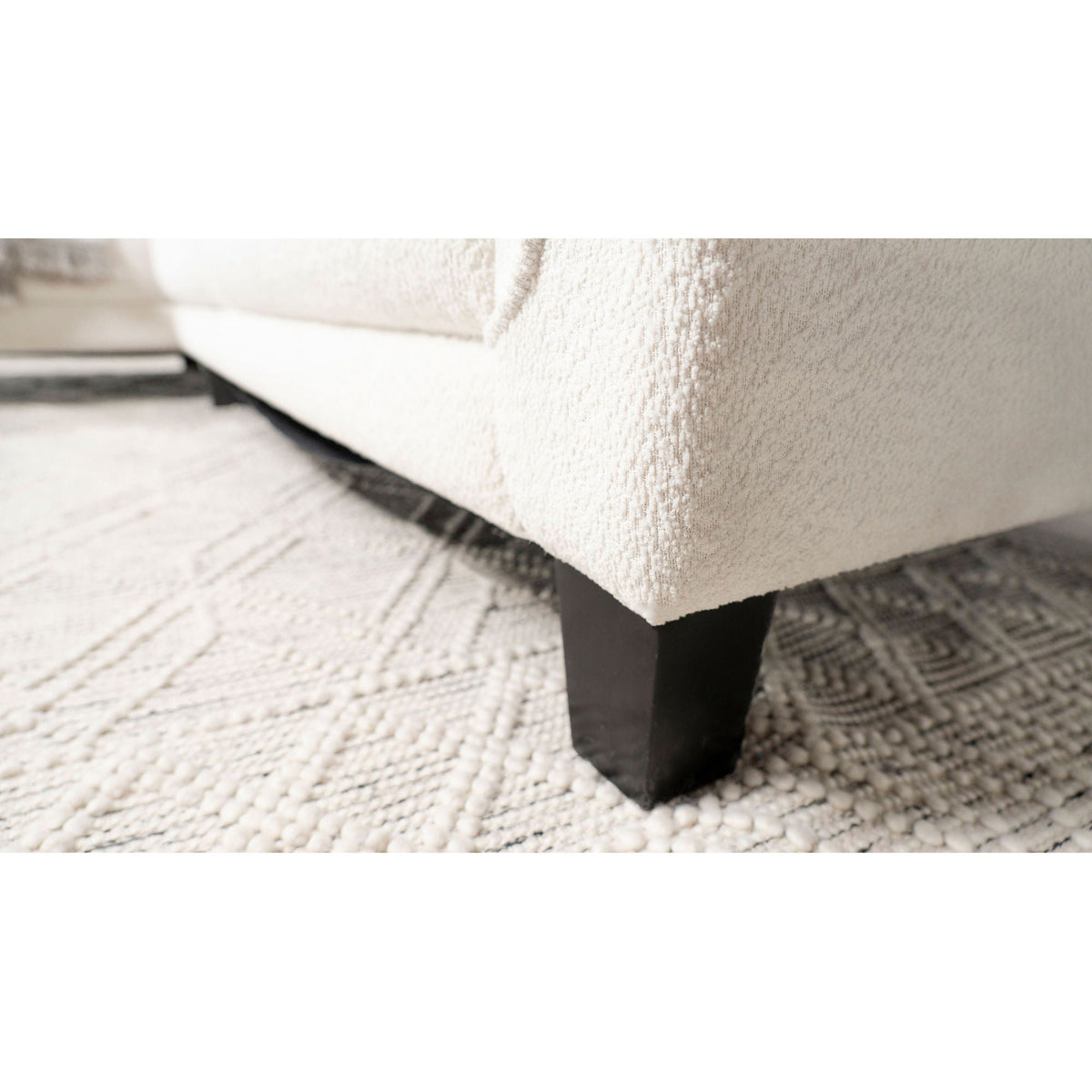 Granholm upholstered curved arm sectional sofa in white fabric with black block legs close-up on Tampa Home & Garden Store