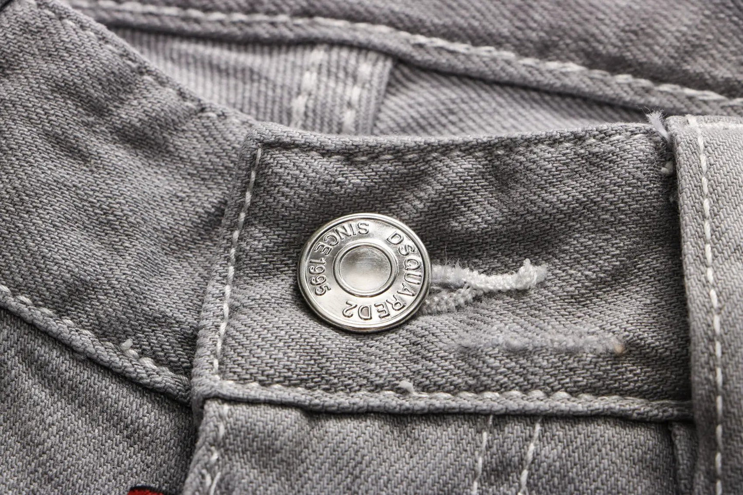 Grey Hong Kong Feng Shui wash men's jeans close-up of pocket with metal button and red tag on Tampa Home & Garden Store