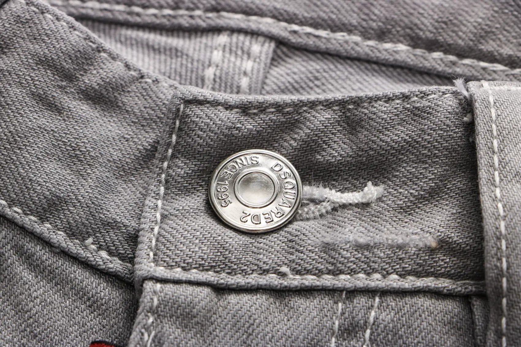 Grey Hong Kong Feng Shui wash men's jeans close-up of pocket with metal button and red tag on Tampa Home & Garden Store